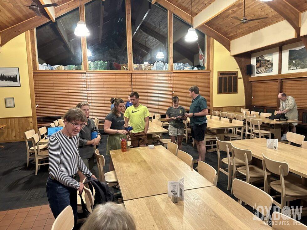 a group of people standing around a table