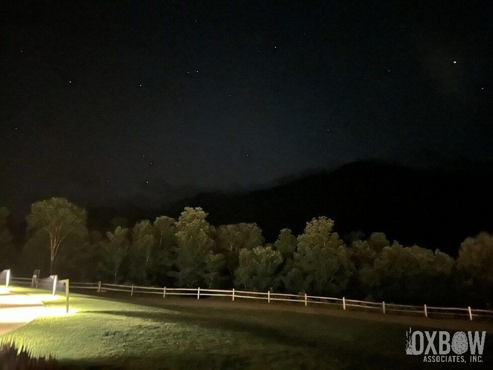 a field with a light on it at night